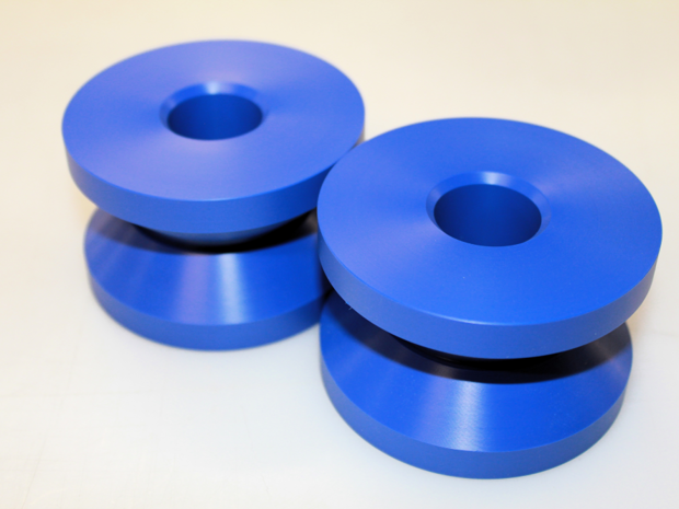 Two machine parts in blue POM.