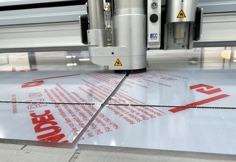 Cutting plotter milling grooving in a clear sheet of polycarbonate