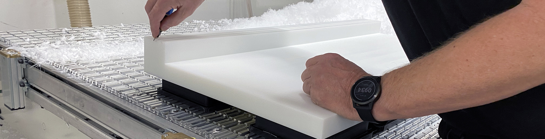 An industrial technician at Induflex finishes a PEHD machine part