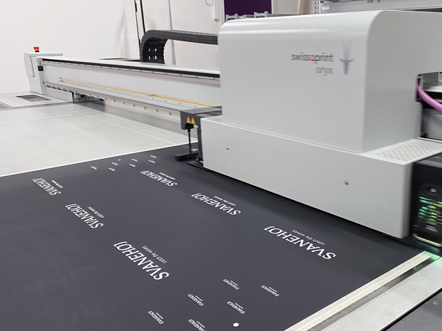 Digital printer printing logo on black rubber