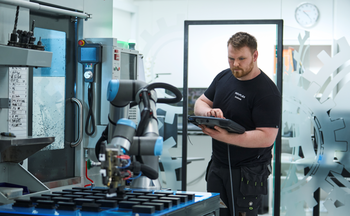 Industrial technician with one of our cobots.