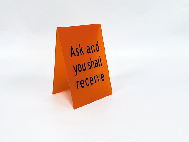 Orange signs in bent, mat acrylic with black print