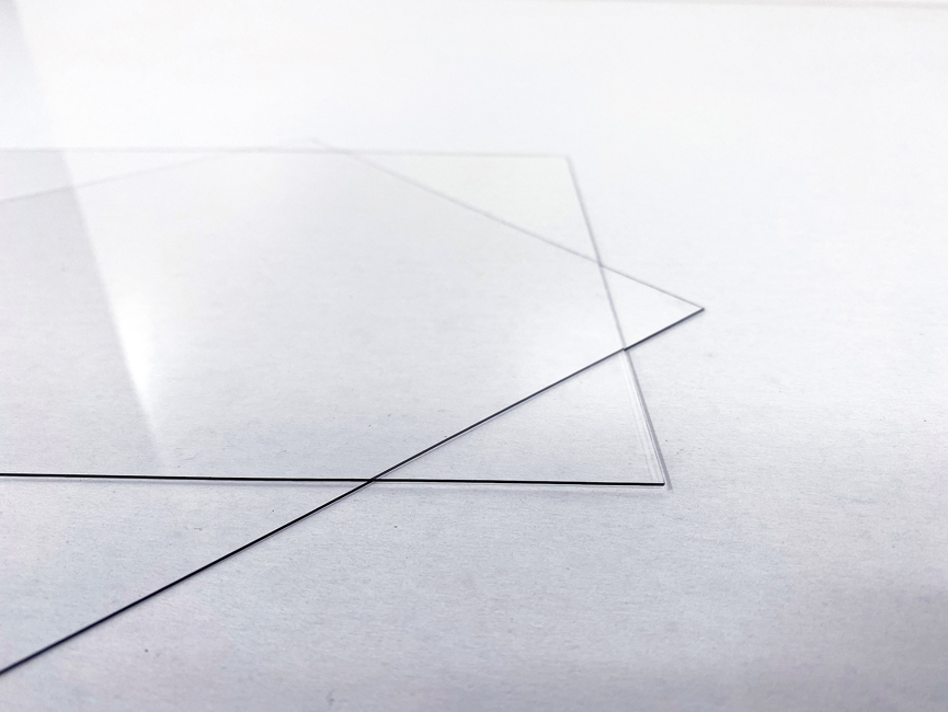 Clear PET plastic sheets on a white background