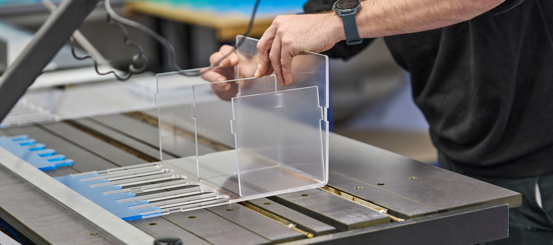 A display of acrylic is heat bent by an employee at Induflex.