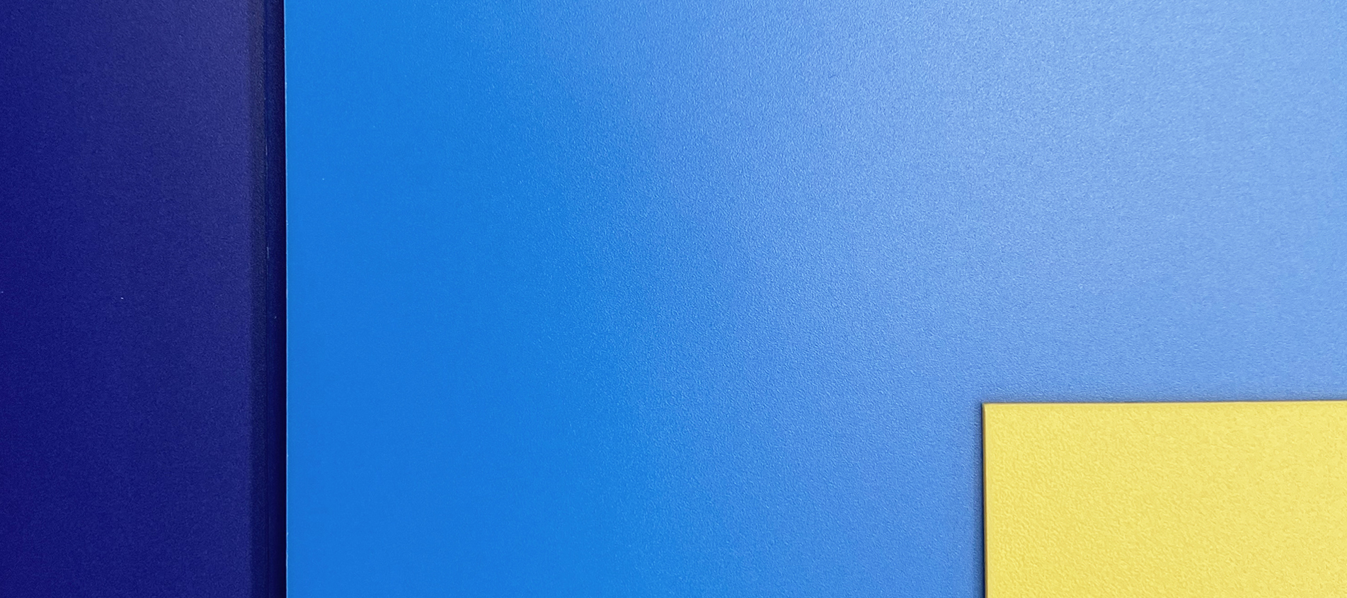 Three sheets of polypropylene in yellow, light blue and dark blue