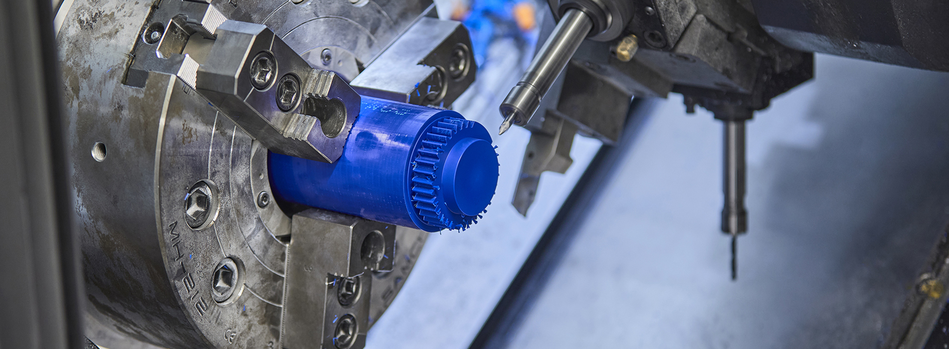 CNC turning of a gear in blue plastic with many serrations