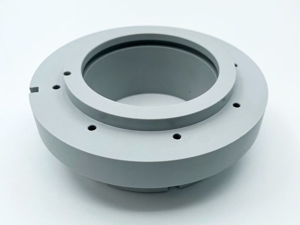 A grey machine part made of PET-P with teflon