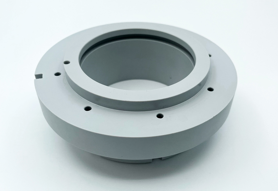 A grey machine part made of PET-P with teflon