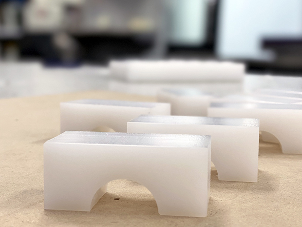CNC milled parts in white technical plastic at Induflex's technical workshop