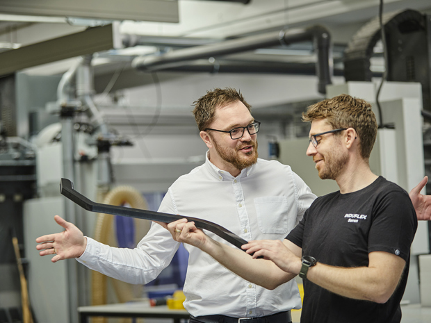 Sales Manager and industry technician talks about a part in the workshop at Induflex