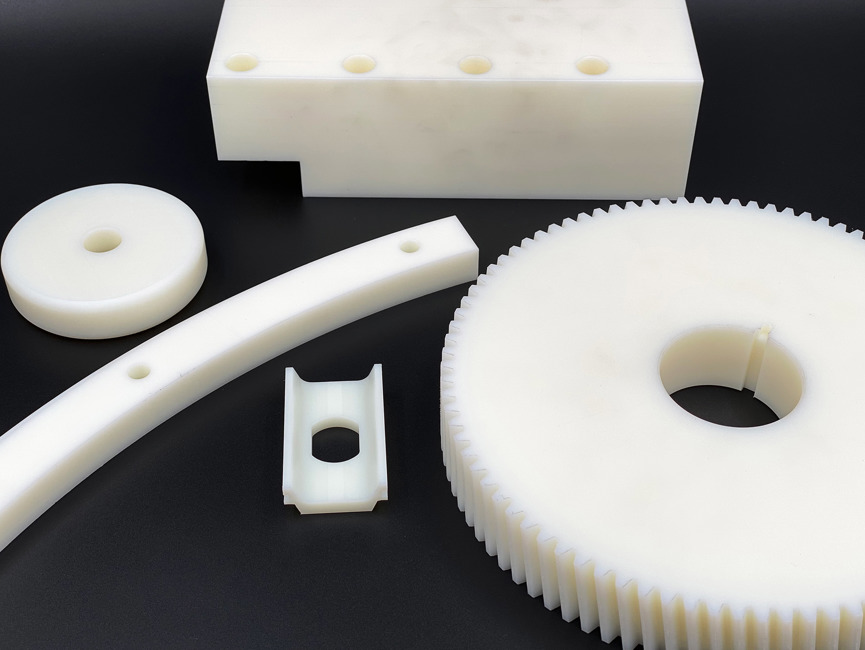 Five various machine parts made from white nylon