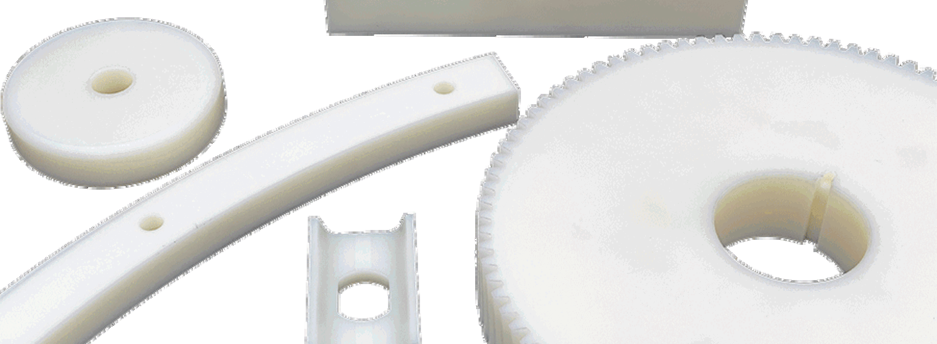 Five various machine parts made from white nylon