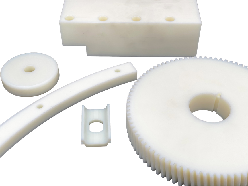 Five various machine parts made from white nylon
