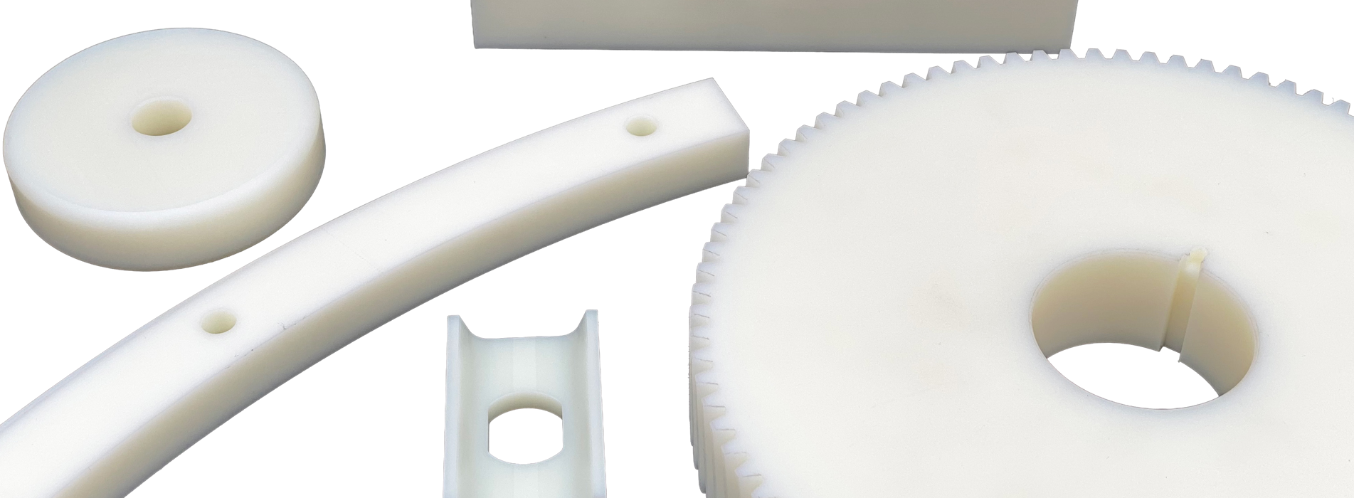Five various machine parts made from white nylon