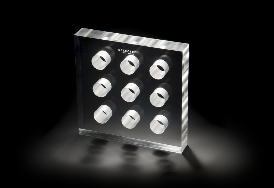 Store display in clear acrylic with nine laser cutted holes