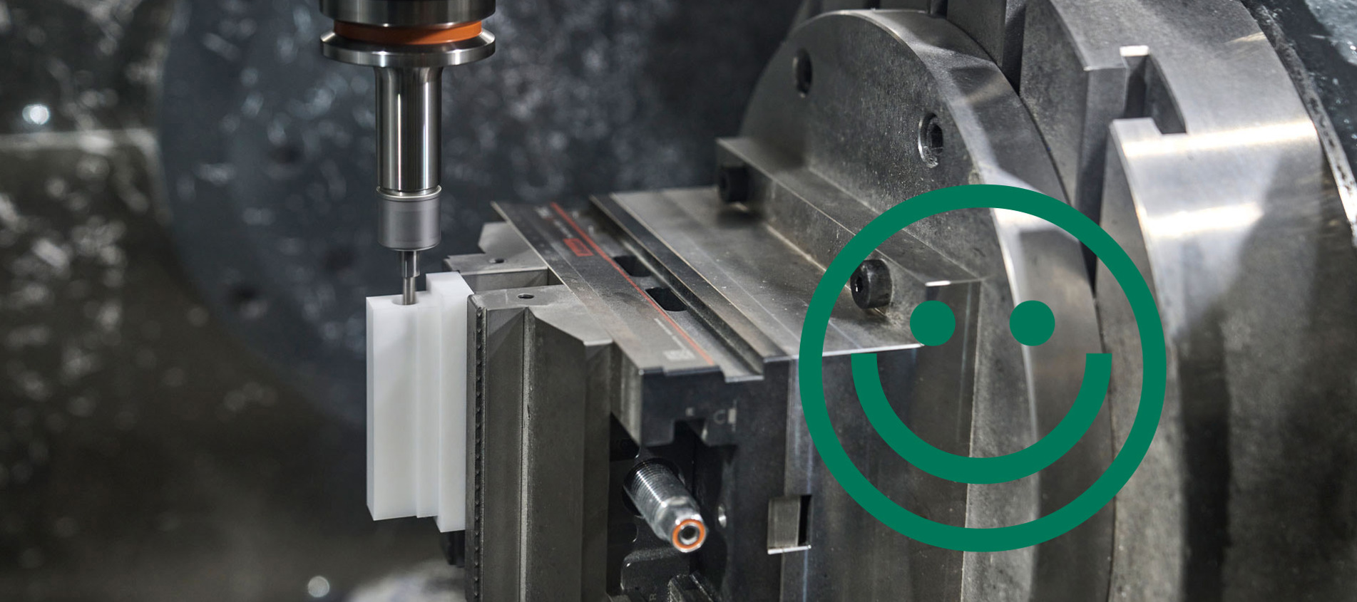 A white machine part made from plastic is being milled