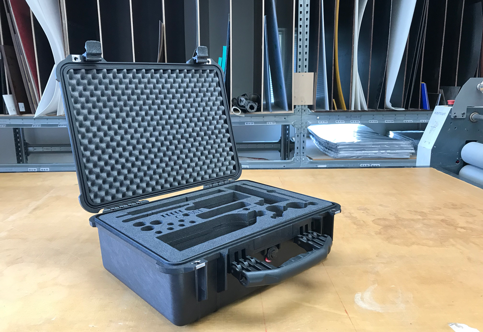 Kuffert med speciallavet skumindlæg vandskåret hos Induflex står åben på bord