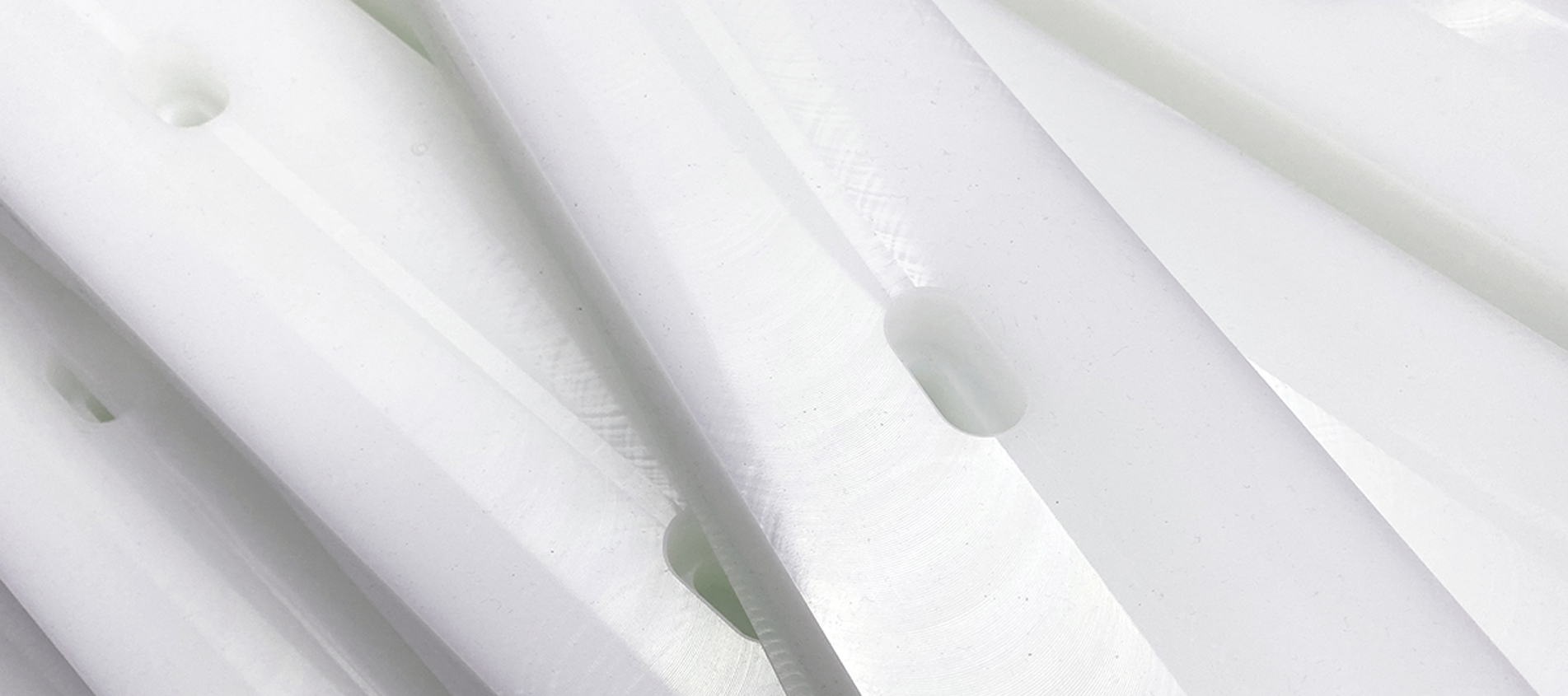 CNC processed plastic parts with holes in white plastic