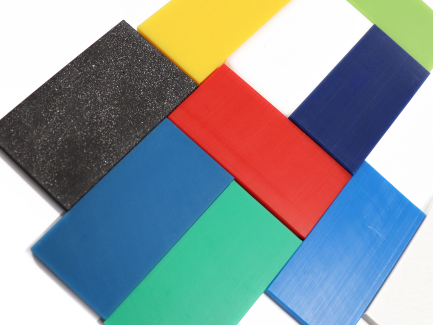 PEHD plastics in various colours as blue, green, yellow, white and black on a table