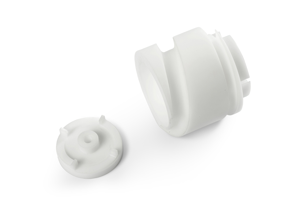 To snegle i hvidt teknisk plast fra Induflex' CNC-bearbejdningscenter